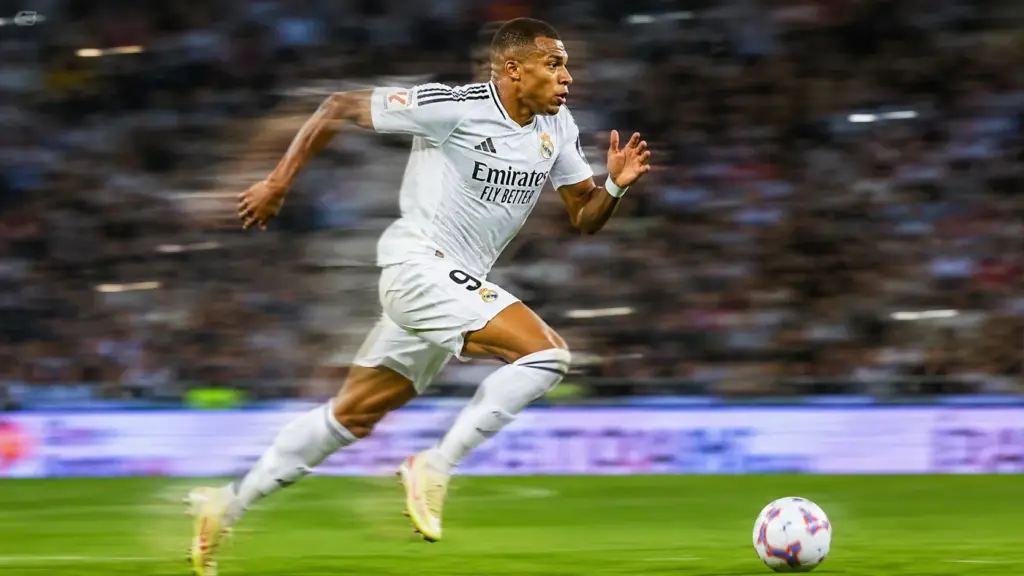 Kylian Mbappe sprinting past defenders during an international football match